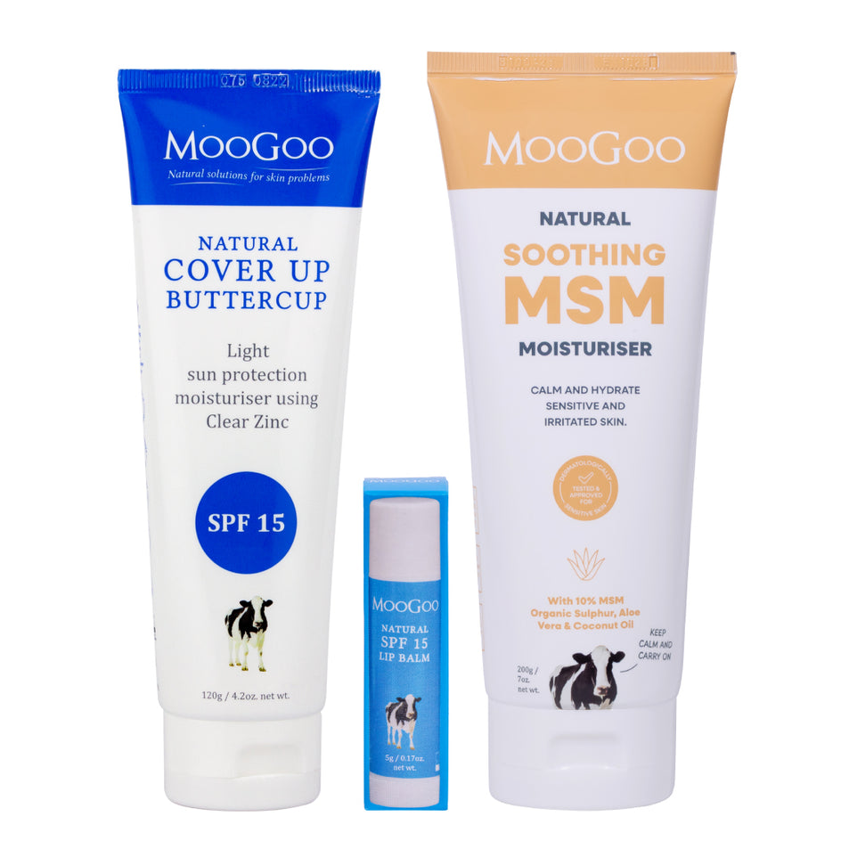A three-piece MooGoo skincare set featuring a blue and white Natural Cover Up Buttercup SPF 15 tube, a blue and white Natural SPF 15 Lip Balm tube, and a white and orange Natural Soothing MSM Moisturiser tube, all on a plain white background. MooGoo Summer Essentials pack for sun care and after sun care.