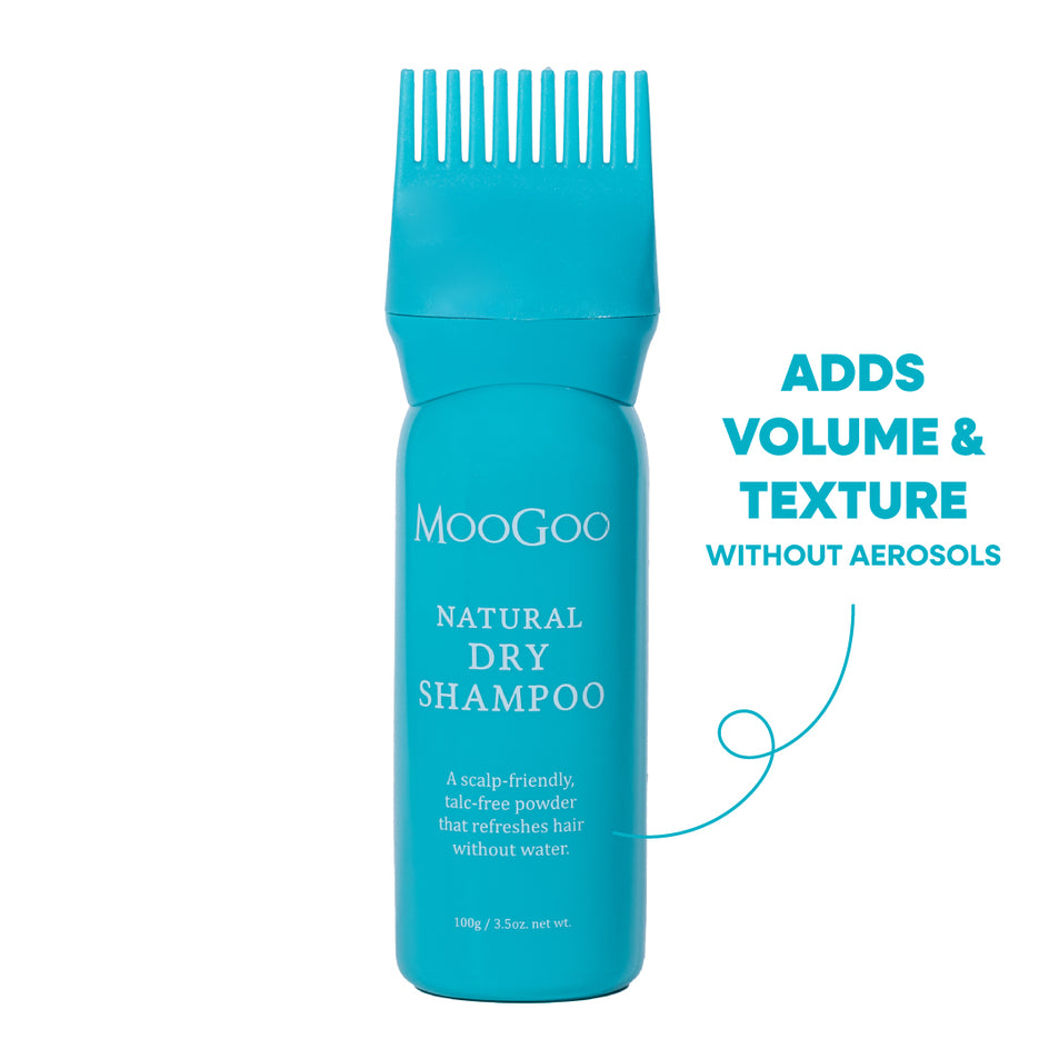A turquoise blue bottle of MooGoo Natural Dry Shampoo with a matching wide-tooth comb applicator on top, shown on a white background. 